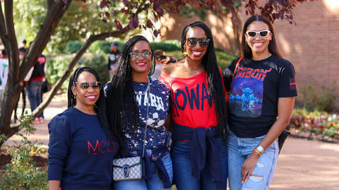 4 female HU alumni posing for a photo